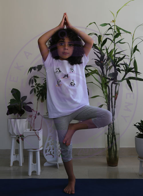 کودکان در حال انجام وضعیت درخت یوگا در کلاس یوگای کودک